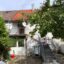 Sanierungsfahrplan von einem Mehrfamilienhaus in Schönaich (Baden-Württemberg) – Gartenansicht des Gebäudes